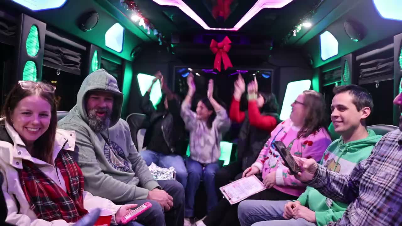 A group celebrating inside a lit party bus