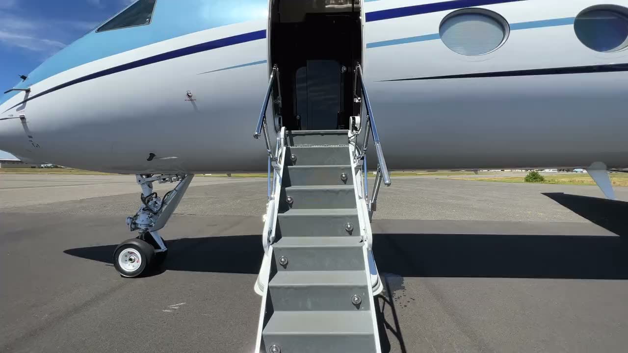 A private jet on the ramp with its airstair down